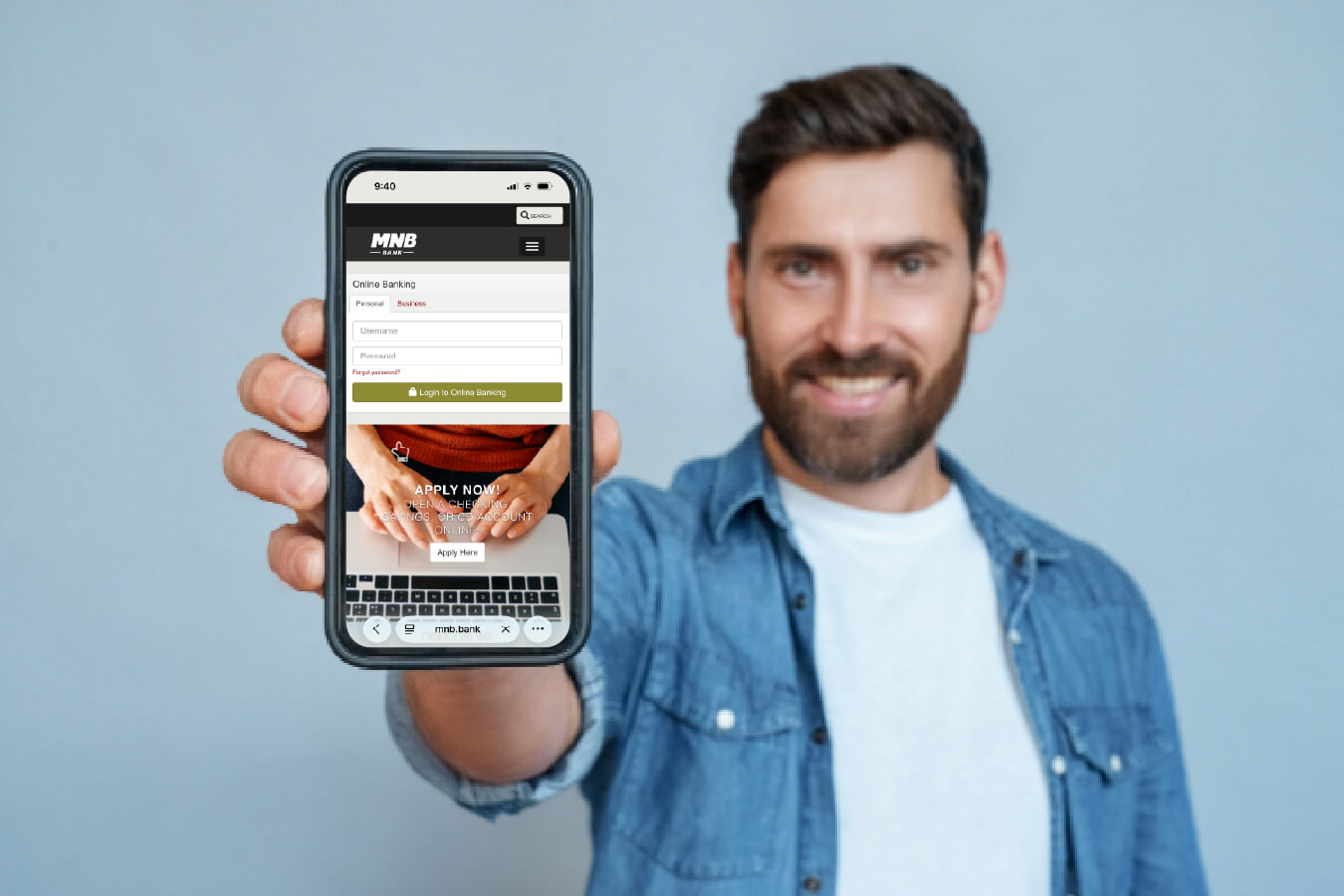 Man holding phone with MNB mobile banking